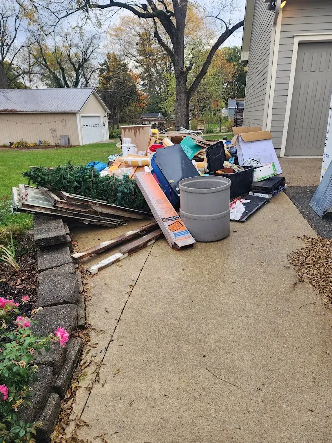 Dumpster being loaded with debris for 12 Yard Dumpster Rental in Luling